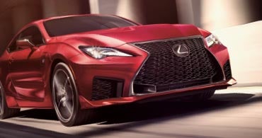 Red Lexus driving down the road