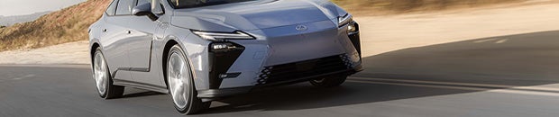 Red Lexus driving down the road